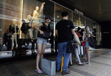 Mainland Chinese customers line up outside a Prada store at Hong Kong's shopping Tsim Sha Tsui district September 16, 2013, one day before t Mainland Chinese customers line up outside a Prada store at Hong Kong's shopping Tsim Sha Tsui district September 16, 2013, one day before t