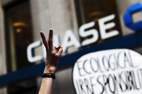 An Occupy Wall Street protestor flashes a peace sign during a march on Broadway past a Chase bank in New York's financial district September An Occupy Wall Street protestor flashes a peace sign during a march on Broadway past a Chase bank in New York's financial district September