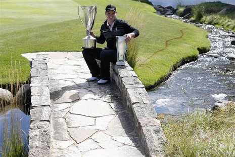 Zach Johnson of U.S. poses with the trophy after winning the BMW Championship golf tournament at the Conway Farms Golf Club in Lake Forest, Zach Johnson of U.S. poses with the trophy after winning the BMW Championship golf tournament at the Conway Farms Golf Club in Lake Forest,