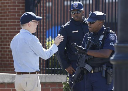 A visitor at the main gate of the Washington Navy Yard is stopped to have his identification checked in Washington, September 17, 2013. REUT A visitor at the main gate of the Washington Navy Yard is stopped to have his identification checked in Washington, September 17, 2013. REUT
