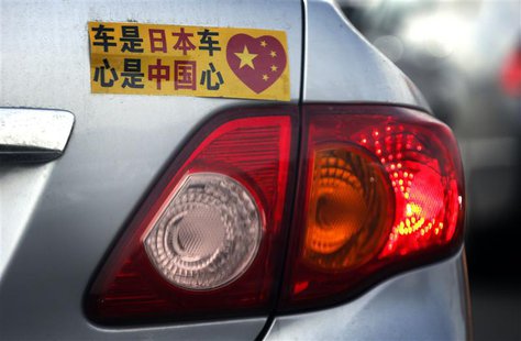 A Toyota car with a sticker attached to the rear can be seen along a main road in central Beijing in this October 16, 2012 file photo. REUTE A Toyota car with a sticker attached to the rear can be seen along a main road in central Beijing in this October 16, 2012 file photo. REUTE