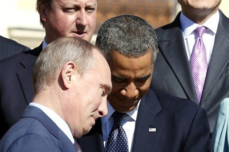 Russian President Vladimir Putin (L) walks past U.S. President Barack Obama (C) during a group photo at the G20 Summit in St. Petersburg in Russian President Vladimir Putin (L) walks past U.S. President Barack Obama (C) during a group photo at the G20 Summit in St. Petersburg in