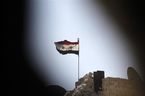 A Syrian national flag flutters over a building controlled by forces loyal to President Bashar Al-Assad in Ashrafieh, Aleppo September 17, 2 A Syrian national flag flutters over a building controlled by forces loyal to President Bashar Al-Assad in Ashrafieh, Aleppo September 17, 2