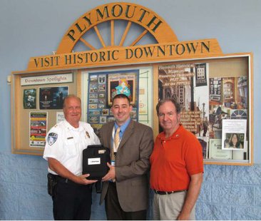 Plymouth Police Chief Jeff Tauscheck, Plymouth Walmart Manager Scott VanStraten, and Mayor Don Pohlman (left to right) posing with a new AED device for the Plymouth Police Department Plymouth Police Chief Jeff Tauscheck, Plymouth Walmart Manager Scott VanStraten, and Mayor Don Pohlman (left to right) posing with a new AED device for the Plymouth Police Department