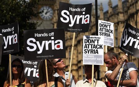 Demonstrators hold placards outside the Houses of Parliament in London in this August 29, 2013 file picture.
REUTERS/Suzanne Plunkett Demonstrators hold placards outside the Houses of Parliament in London in this August 29, 2013 file picture.
REUTERS/Suzanne Plunkett