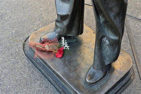 A lone bouquet of flowers is left at the base of a statue at the Navy Memorial in Washington, to honor the victims of the attack at the Navy A lone bouquet of flowers is left at the base of a statue at the Navy Memorial in Washington, to honor the victims of the attack at the Navy