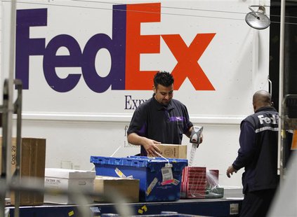 Handlers scan and affix a courier route label onto packages moving down the belt at the Marina Del Rey, California FedEx station December 12 Handlers scan and affix a courier route label onto packages moving down the belt at the Marina Del Rey, California FedEx station December 12