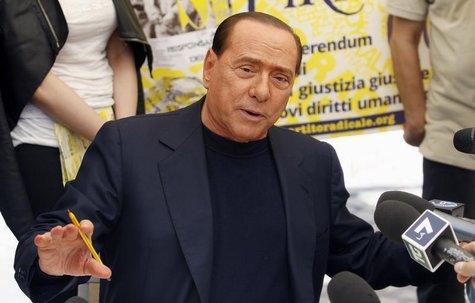 People of Liberty party (PDL) leader Silvio Berlusconi talks with reporters as he signs a referendum on justice reforms and human rights in People of Liberty party (PDL) leader Silvio Berlusconi talks with reporters as he signs a referendum on justice reforms and human rights in