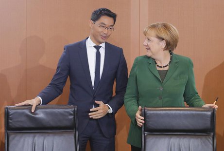 German Chancellor Angela Merkel and Economy Minister Philipp Roesler arrive for the weekly cabinet meeting in Berlin, September 18, 2013. RE German Chancellor Angela Merkel and Economy Minister Philipp Roesler arrive for the weekly cabinet meeting in Berlin, September 18, 2013. RE