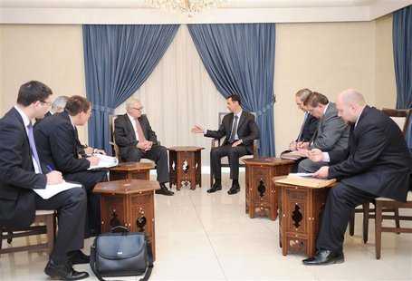 Syria's President Bashar al-Assad (centre, on R) meets Russian deputy Foreign Minister Sergei Ryabkov (centre, on L) in Damascus, in this ha Syria's President Bashar al-Assad (centre, on R) meets Russian deputy Foreign Minister Sergei Ryabkov (centre, on L) in Damascus, in this ha