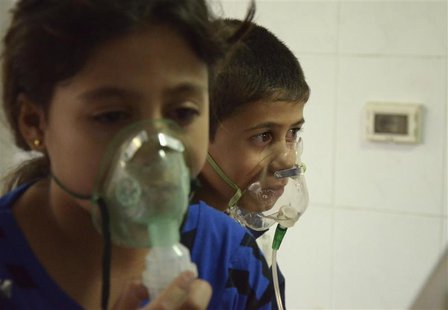 Children, affected by what activists say was a gas attack, breathe through oxygen masks in the Damascus suburb of Saqba, August 21, 2013. RE Children, affected by what activists say was a gas attack, breathe through oxygen masks in the Damascus suburb of Saqba, August 21, 2013. RE