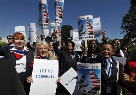 US Airways flight attendants chant during a protest by pilots, flight attendants, baggage handlers and other union members working for Ameri US Airways flight attendants chant during a protest by pilots, flight attendants, baggage handlers and other union members working for Ameri