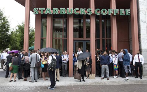 People stand outside a Starbucks Coffee shop that has been closed as police respond to a shooting at the Washington Navy Yard in Washington, People stand outside a Starbucks Coffee shop that has been closed as police respond to a shooting at the Washington Navy Yard in Washington,