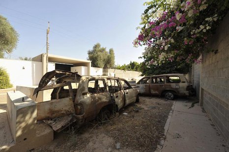 The remnants of cars from an attack on the U.S. Consulate, which killed U.S. Ambassador Christopher Stevens, are seen near the wall of the c The remnants of cars from an attack on the U.S. Consulate, which killed U.S. Ambassador Christopher Stevens, are seen near the wall of the c