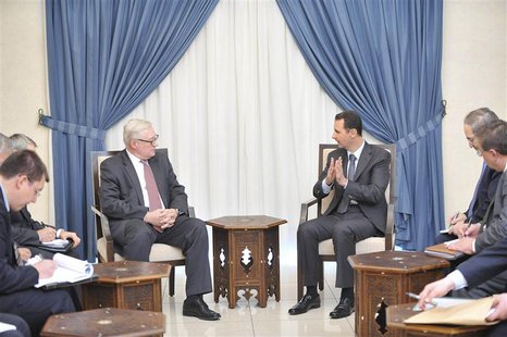 Syria's President Bashar al-Assad (centre, on R) meets Russian deputy Foreign Minister Sergei Ryabkov (centre, on L) in Damascus, in this ha Syria's President Bashar al-Assad (centre, on R) meets Russian deputy Foreign Minister Sergei Ryabkov (centre, on L) in Damascus, in this ha