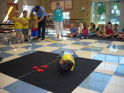 Jefferson Elementary first grade student Sienna Lee demonstrating how to stop, drop, and roll Jefferson Elementary first grade student Sienna Lee demonstrating how to stop, drop, and roll