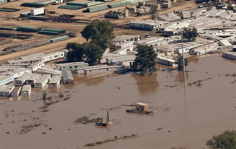 An oil storage tank on a well pad lies toppled near portable buildings surrounded with flood waters in Weld County, Colorado September 17, 2 An oil storage tank on a well pad lies toppled near portable buildings surrounded with flood waters in Weld County, Colorado September 17, 2