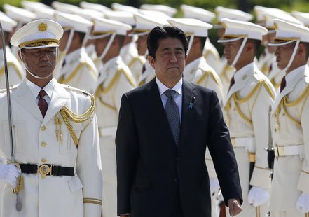 Japan's Prime Minister Shinzo Abe reviews the honour guard before a meeting with Japan Self-Defense Force's senior members at the Defense Mi Japan's Prime Minister Shinzo Abe reviews the honour guard before a meeting with Japan Self-Defense Force's senior members at the Defense Mi