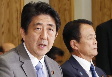 Japan's Prime Minister Shinzo Abe (L), seated with Finance Minister Taro Aso, speaks during the Council on Economic and Fiscal Policy meetin Japan's Prime Minister Shinzo Abe (L), seated with Finance Minister Taro Aso, speaks during the Council on Economic and Fiscal Policy meetin