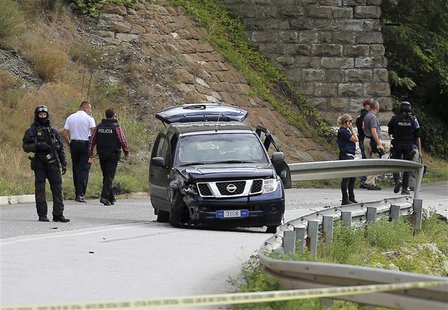 European Union police officers secure the site near Kosovo's town of Zvecan where one of their colleagues was shot dead, September 19, 2013. European Union police officers secure the site near Kosovo's town of Zvecan where one of their colleagues was shot dead, September 19, 2013.