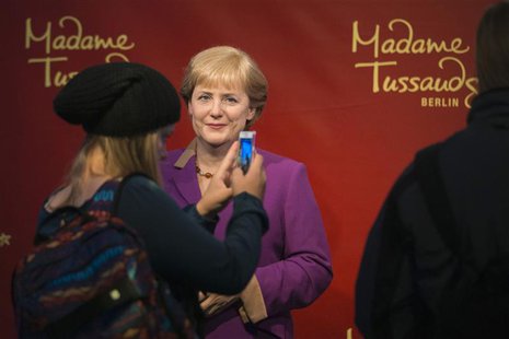 A tourist takes a picture of the wax figure of German Chancellor Angela Merkel at the Madame Tussauds wax museum in Berlin, September 19, 20 A tourist takes a picture of the wax figure of German Chancellor Angela Merkel at the Madame Tussauds wax museum in Berlin, September 19, 20