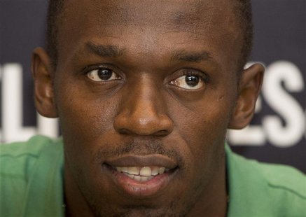 Jamaican athlete Usain Bolt poses for photographers as he signs copies of his autobiography, "Faster than Lightning," at Selfridges in centr Jamaican athlete Usain Bolt poses for photographers as he signs copies of his autobiography, "Faster than Lightning," at Selfridges in centr