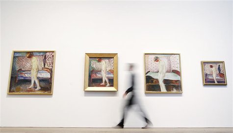 Duncan Holden of the Tate poses with four paintings of Edvard Munch's "Weeping Woman" series at the Tate Modern in London's Southbank, June Duncan Holden of the Tate poses with four paintings of Edvard Munch's "Weeping Woman" series at the Tate Modern in London's Southbank, June