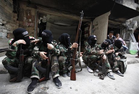 Female members of the "Mother Aisha" battalion sit together along a street in Aleppo's Salaheddine district, September 19, 2013. REUTERS/Lou Female members of the "Mother Aisha" battalion sit together along a street in Aleppo's Salaheddine district, September 19, 2013. REUTERS/Lou