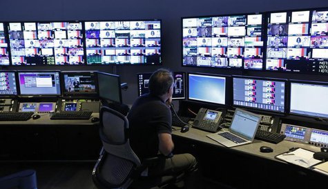 A technician works in the "Acquisition Room", which receives televison feeds from around the world, during an event to mark the opening of t A technician works in the "Acquisition Room", which receives televison feeds from around the world, during an event to mark the opening of t