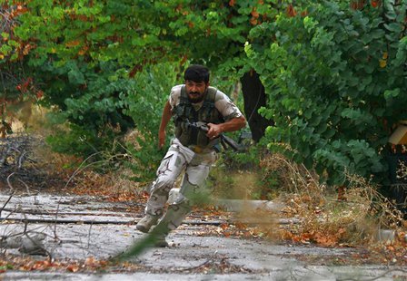 A Free Syrian Army fighter runs for cover from snipers loyal to Syria's President Bashar al-Assad in the Al-Sakhour neighborhood of Aleppo S A Free Syrian Army fighter runs for cover from snipers loyal to Syria's President Bashar al-Assad in the Al-Sakhour neighborhood of Aleppo S