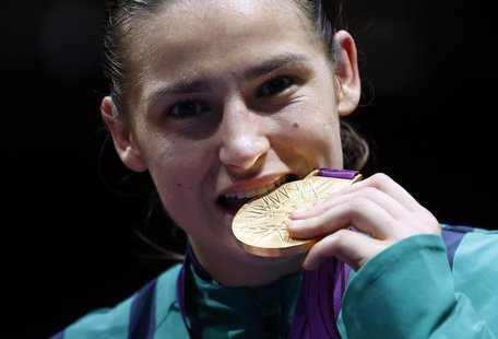 Katie Taylor of Ireland bites her gold medal following the presentation ceremony for the Women's Light (60kg) boxing competition at the Lond Katie Taylor of Ireland bites her gold medal following the presentation ceremony for the Women's Light (60kg) boxing competition at the Lond