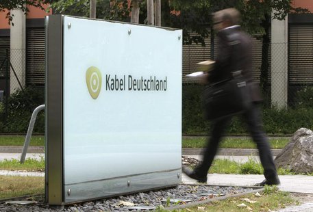A man passes the company logo of German cable television group Kabel Deutschland in Unterfoehring north of Munich June 24, 2013. REUTERS/Mic A man passes the company logo of German cable television group Kabel Deutschland in Unterfoehring north of Munich June 24, 2013. REUTERS/Mic