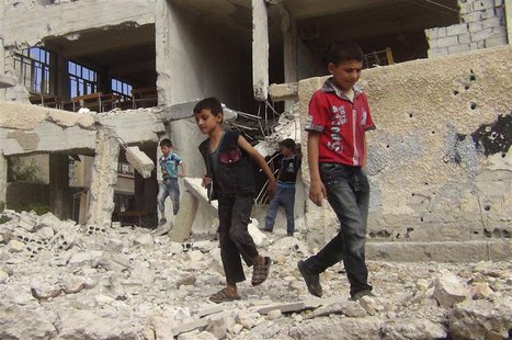 Children walk among debris from a damaged school building in the Damascus suburb of Zamalka September 19, 2013. Picture taken September 19, Children walk among debris from a damaged school building in the Damascus suburb of Zamalka September 19, 2013. Picture taken September 19,