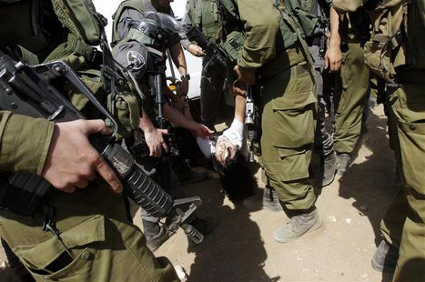 Israeli soldiers carry French diplomat Marion Castaing after removing her from her truck containing emergency aid, in the West Bank herding Israeli soldiers carry French diplomat Marion Castaing after removing her from her truck containing emergency aid, in the West Bank herding