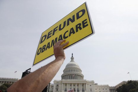 A man holds a sign at the Tea Party Patriots 'Exempt America from Obamacare' rally on the west lawn of the U.S. Capitol in Washington, Septe A man holds a sign at the Tea Party Patriots 'Exempt America from Obamacare' rally on the west lawn of the U.S. Capitol in Washington, Septe