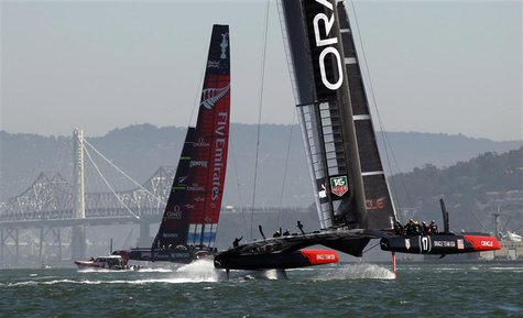 Emirates Team New Zealand (L) and Oracle Team USA sail after rounding the first mark during Race 12 of the 34th America's Cup yacht sailing Emirates Team New Zealand (L) and Oracle Team USA sail after rounding the first mark during Race 12 of the 34th America's Cup yacht sailing
