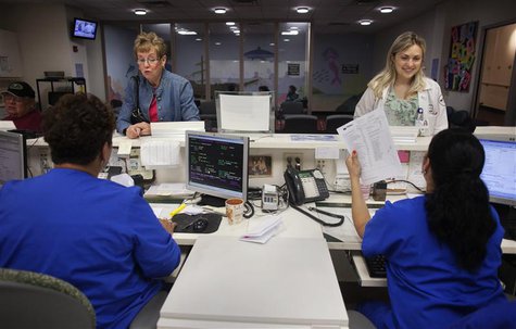 Patient Eilleen Corrigin (L) stands next to a nurse while checking in for an appointment at an anti-coagulation clinic at the Staten Island Patient Eilleen Corrigin (L) stands next to a nurse while checking in for an appointment at an anti-coagulation clinic at the Staten Island
