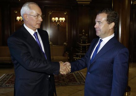 Russia's Prime Minister Dmitry Medvedev (R) shakes hands with his Ukrainian counterpart Mykola Azarov during a meeting at the Gorki state re Russia's Prime Minister Dmitry Medvedev (R) shakes hands with his Ukrainian counterpart Mykola Azarov during a meeting at the Gorki state re