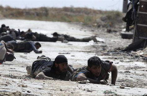 Free Syrian Army fighters take cover from snipers by crawling on the front line in Aleppo's Sheikh Saeed neighbourhood September 21, 2013. R Free Syrian Army fighters take cover from snipers by crawling on the front line in Aleppo's Sheikh Saeed neighbourhood September 21, 2013. R