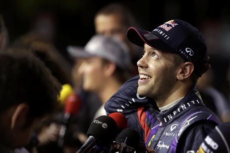 Red Bull Formula One driver Sebastian Vettel of Germany reacts during an interview after the qualifying session of the Singapore F1 Grand Pr Red Bull Formula One driver Sebastian Vettel of Germany reacts during an interview after the qualifying session of the Singapore F1 Grand Pr