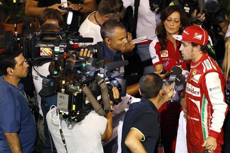 Ferrari Formula One driver Fernando Alonso of Spain is interviewed after the qualifying session of the Singapore F1 Grand Prix at the Marina Ferrari Formula One driver Fernando Alonso of Spain is interviewed after the qualifying session of the Singapore F1 Grand Prix at the Marina