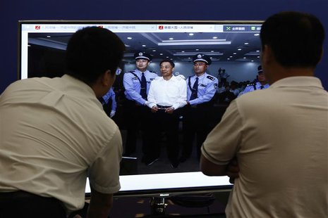 Men look at a screen displaying a picture of disgraced Chinese politician Bo Xilai standing trial on the website of a court's microblog, in Men look at a screen displaying a picture of disgraced Chinese politician Bo Xilai standing trial on the website of a court's microblog, in