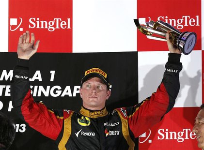 Lotus F1 Formula One driver Kimi Raikkonen of Finland celebrates on the podium after the Singapore F1 Grand Prix at the Marina Bay street ci Lotus F1 Formula One driver Kimi Raikkonen of Finland celebrates on the podium after the Singapore F1 Grand Prix at the Marina Bay street ci