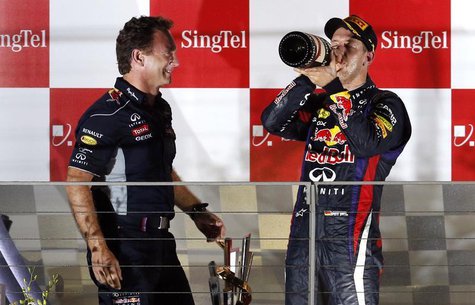 Red Bull team principal Christian Horner (L) stands on the podium with Red Bull Formula One driver Sebastian Vettel of Germany after Vettel Red Bull team principal Christian Horner (L) stands on the podium with Red Bull Formula One driver Sebastian Vettel of Germany after Vettel