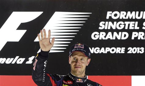 Red Bull Formula One driver Sebastian Vettel of Germany waves on the podium after the Singapore F1 Grand Prix at the Marina Bay street circu Red Bull Formula One driver Sebastian Vettel of Germany waves on the podium after the Singapore F1 Grand Prix at the Marina Bay street circu