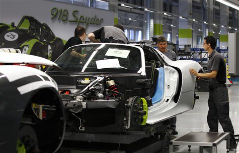 Workers assemble a new Porsche 918-Spyder sports car at the production line of the German car manufacturer's plant in Stuttgart-Zuffenhausen Workers assemble a new Porsche 918-Spyder sports car at the production line of the German car manufacturer's plant in Stuttgart-Zuffenhausen