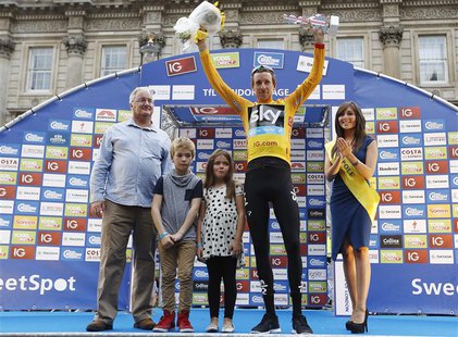 Britain's Bradley Wiggins (2nd R), with his children Ben and Isabella, celebrate being the overall winner of the Tour of Britain and receivi Britain's Bradley Wiggins (2nd R), with his children Ben and Isabella, celebrate being the overall winner of the Tour of Britain and receivi