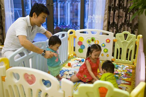 Tony Jiang poses with his three children at his house in Shanghai September 16, 2013. In December 2010, REUTERS/Aly Song Tony Jiang poses with his three children at his house in Shanghai September 16, 2013. In December 2010, REUTERS/Aly Song