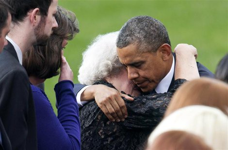 U.S. President Barack Obama hugs a family member of a victim slain in the Washington Navy Yard shooting during a memorial service in Washing U.S. President Barack Obama hugs a family member of a victim slain in the Washington Navy Yard shooting during a memorial service in Washing