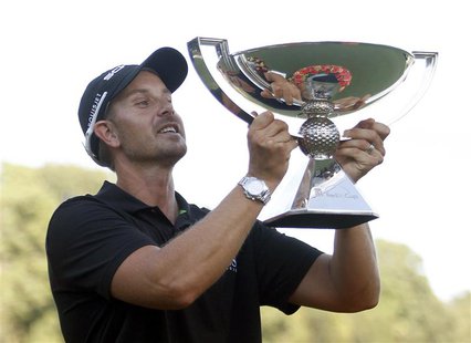 Henrik Stenson of Sweden holds up the FedExCup trophy toward the gallery after winning the the Tour Championship golf tournament at East Lak Henrik Stenson of Sweden holds up the FedExCup trophy toward the gallery after winning the the Tour Championship golf tournament at East Lak